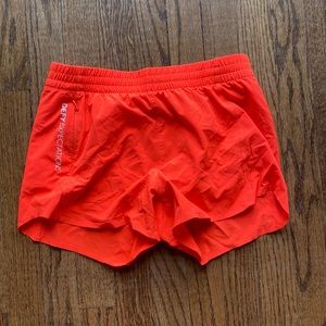 Athleta Girl orange neon running shorts